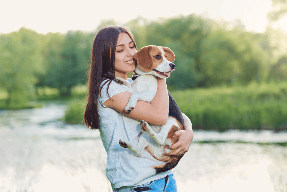 woman holding beagle in her arms